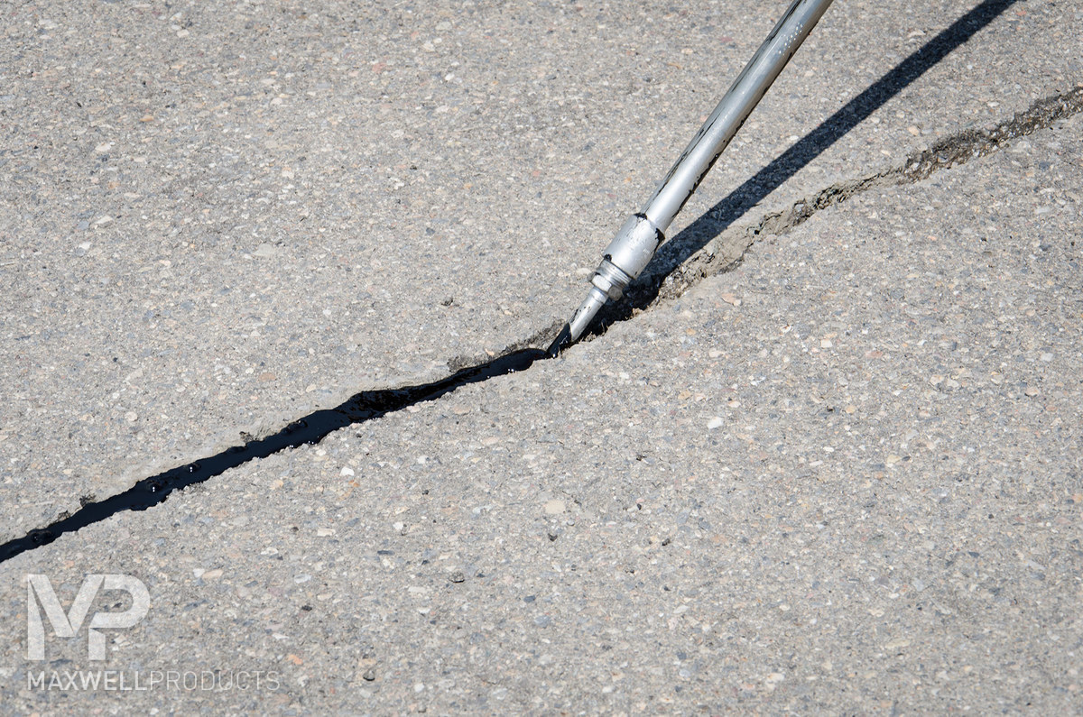Asphalt cracking flush filled with Maxwell Products' crack sealant