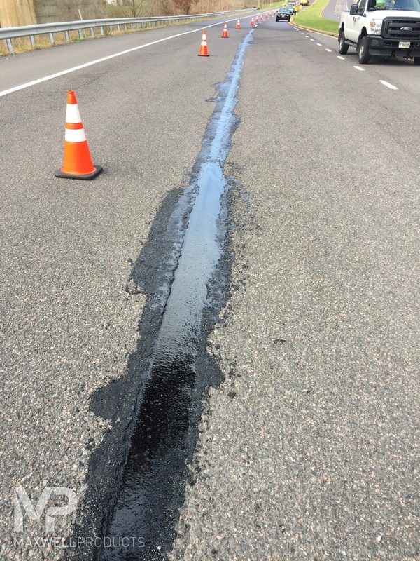 A seam in asphalt pavement is permanently sealed with GAP Mastic.