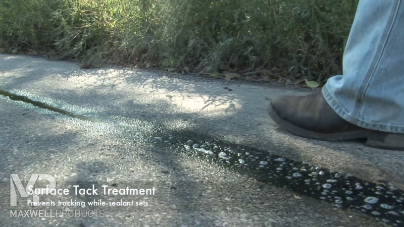 Road crew applies surface tack treatment to prevent tracking while sealant cures.