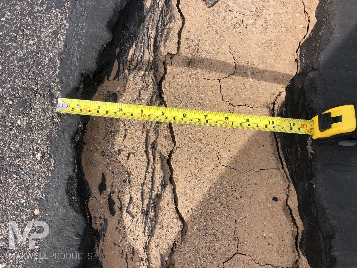 Close up of a wide asphalt crack in Arizona.